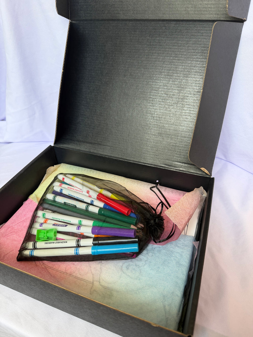 Markers and colored pencils included in the personalized coloring book gift box