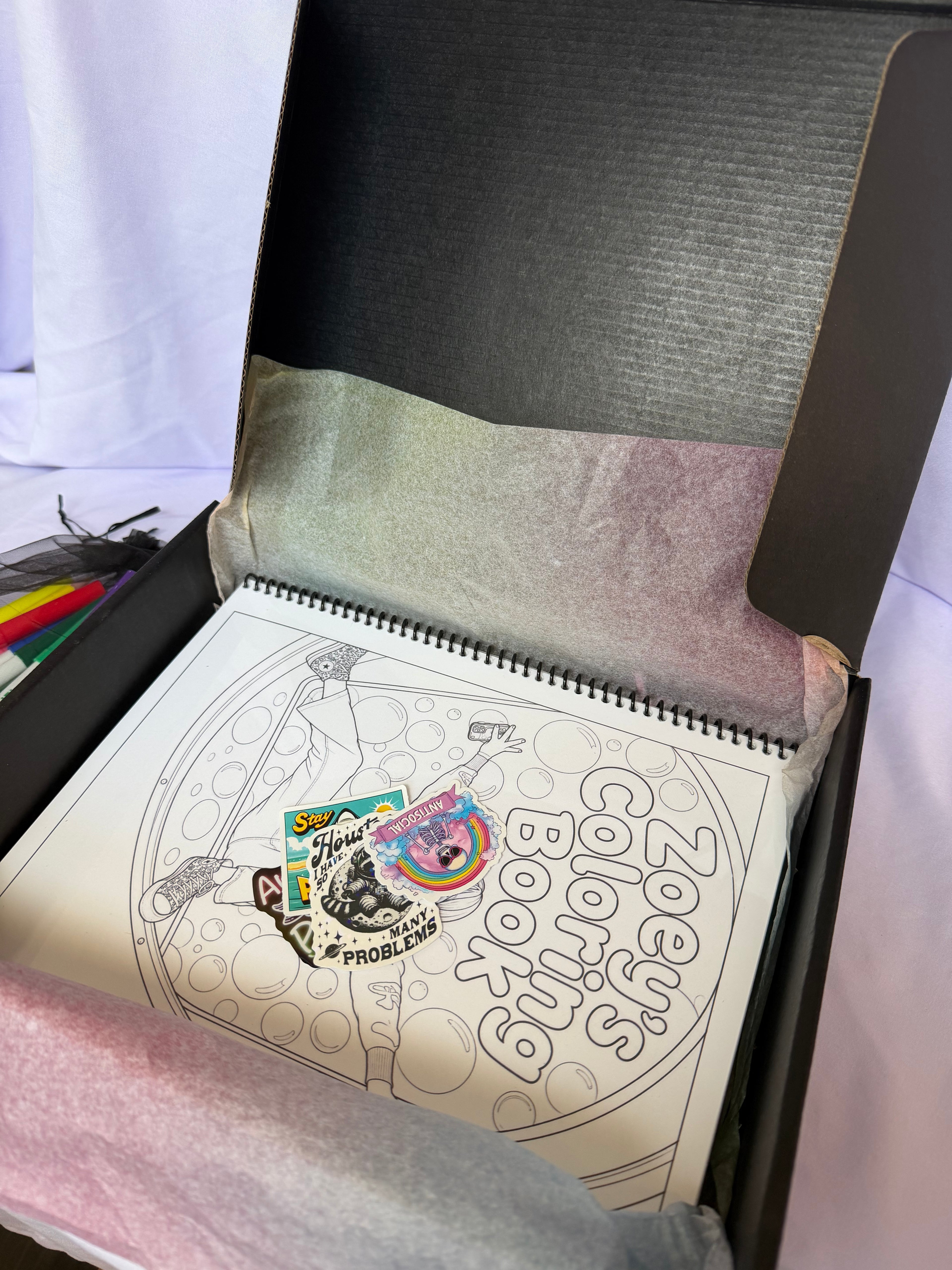 Personalized coloring book and stickers packaged inside a black gift box