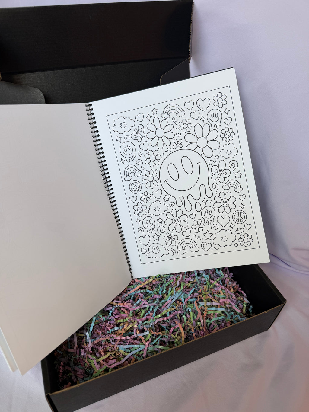 Decorative smiley coloring page in a custom spiral-bound coloring book