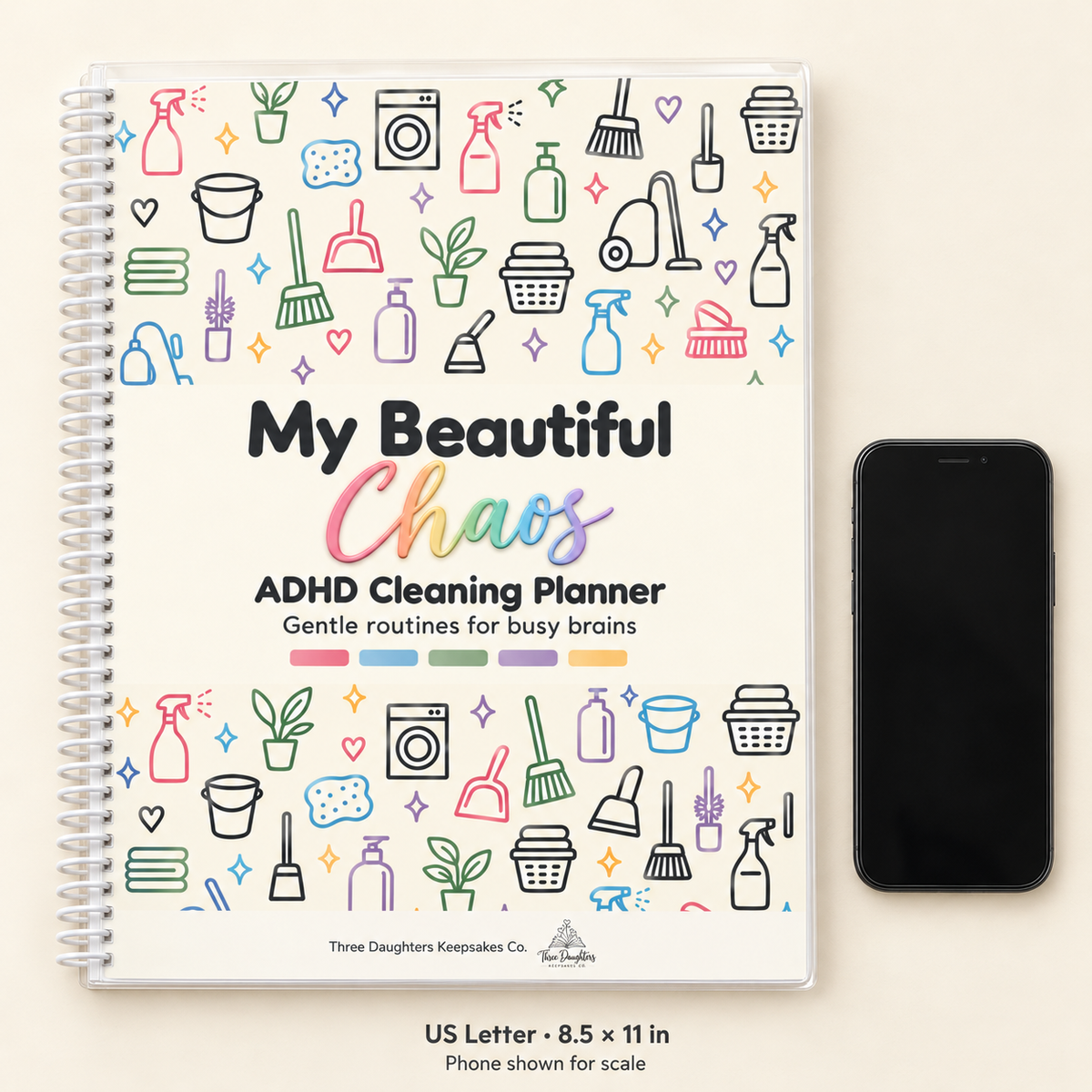 Letter size 8.5 x 11 inch spiral bound ADHD cleaning planner shown next to a smartphone for scale