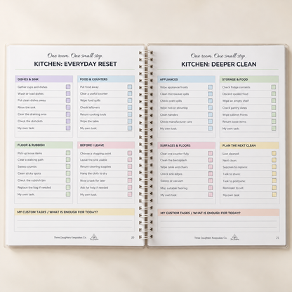 Open spiral cleaning planner showing kitchen everyday reset and kitchen deeper clean checklist pages